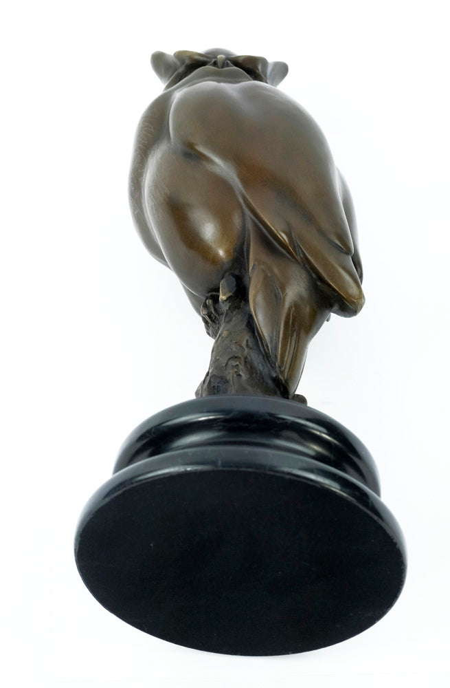 Bronze sculpture of a long-eared owl on a branch