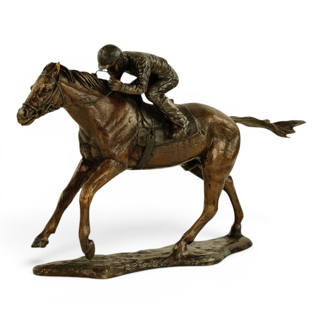 Escultura de bronce de un jinete sobre un caballo de carreras