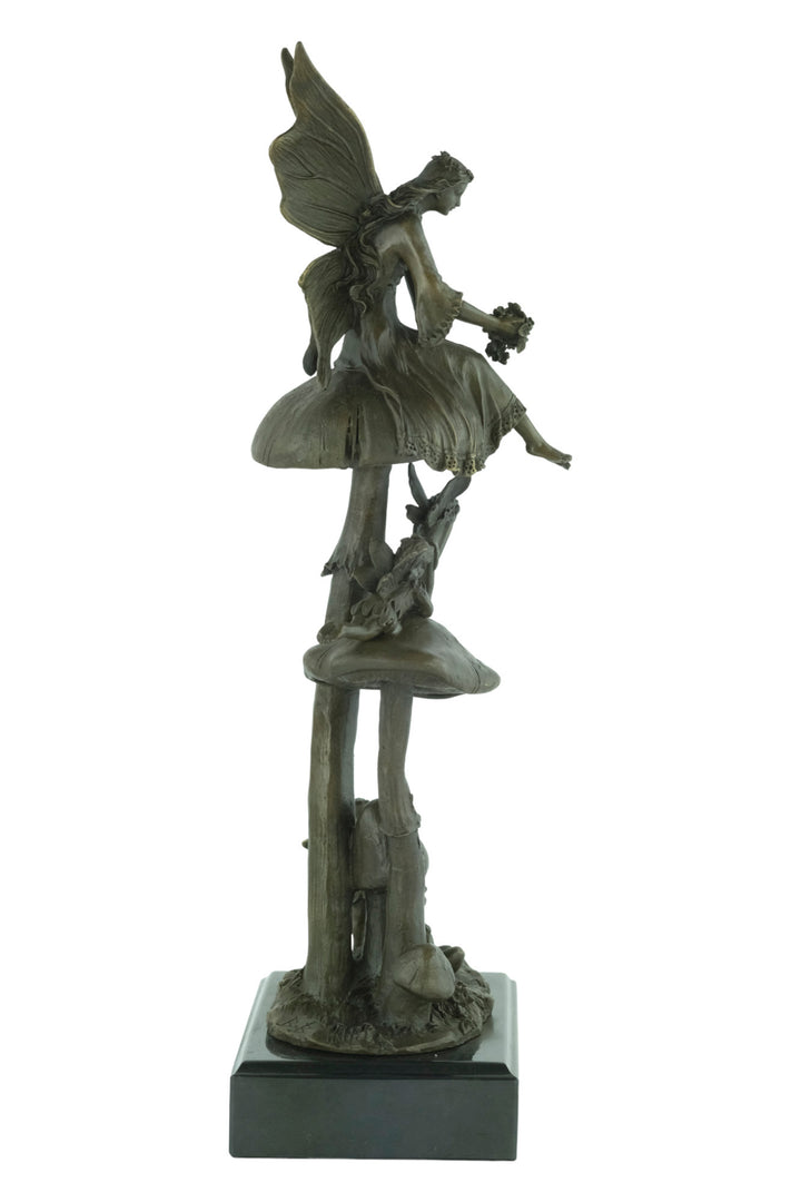 Bronze sculpture of a group of fairies sitting on mushrooms