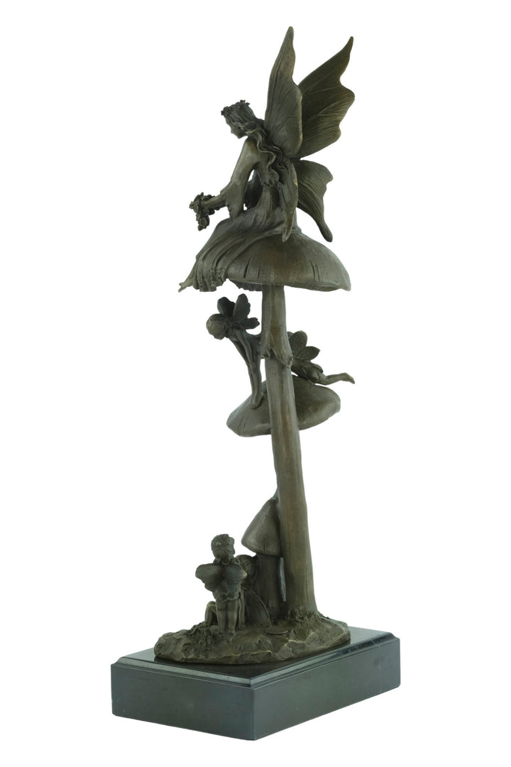 Bronze sculpture of a group of fairies sitting on mushrooms