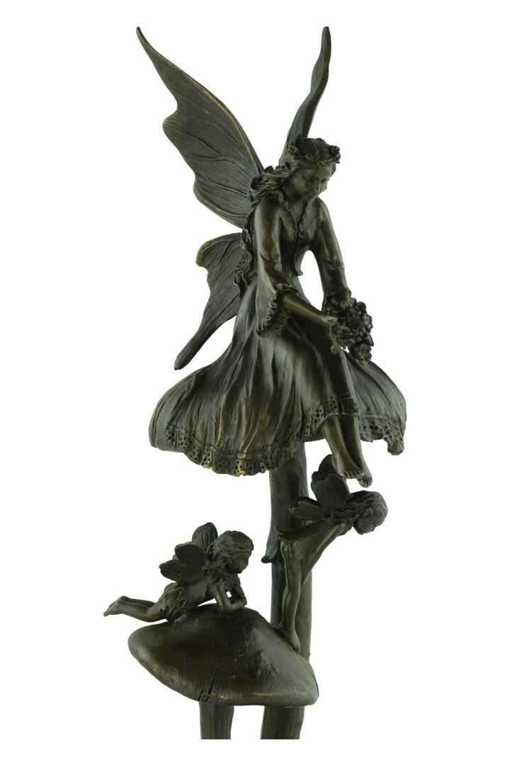 Bronze sculpture of a group of fairies sitting on mushrooms