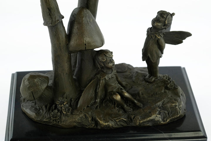 Bronze sculpture of a group of fairies sitting on mushrooms