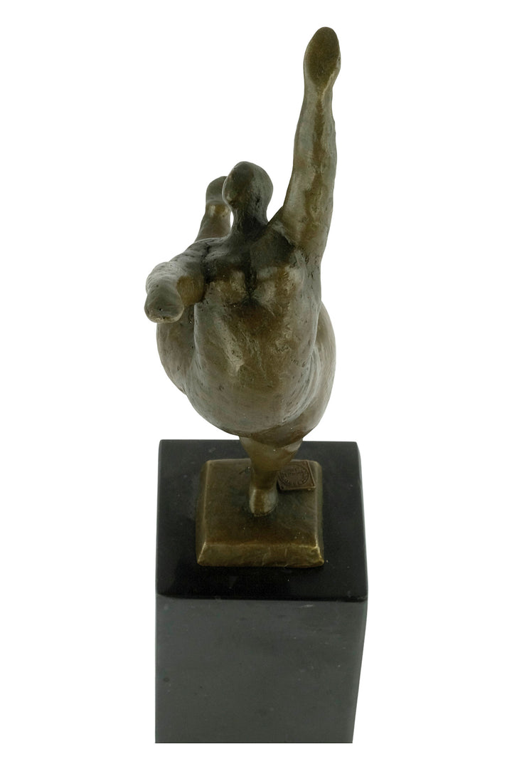 Bronze sculpture of a voluptuous female nude dancing freely