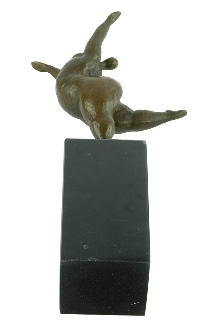Bronze sculpture of a voluptuous female nude dancing freely