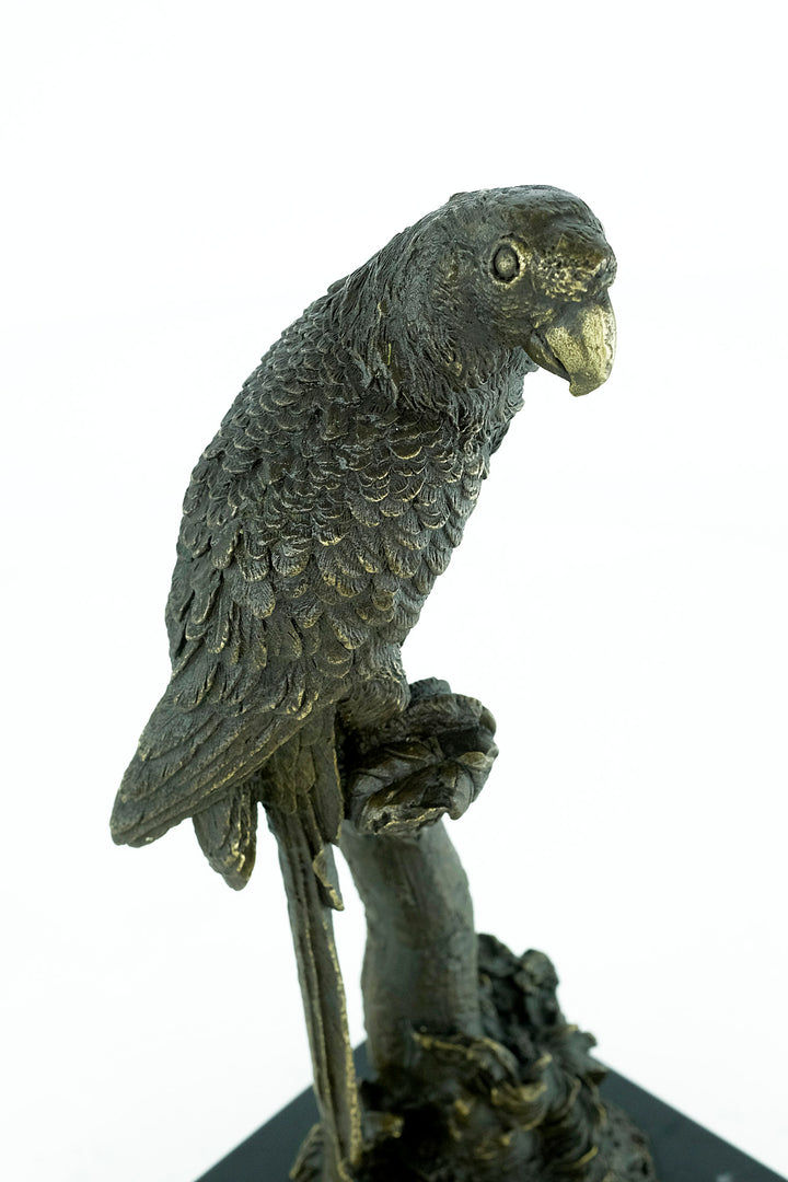 Bronze sculpture of a parrot sitting on a branch