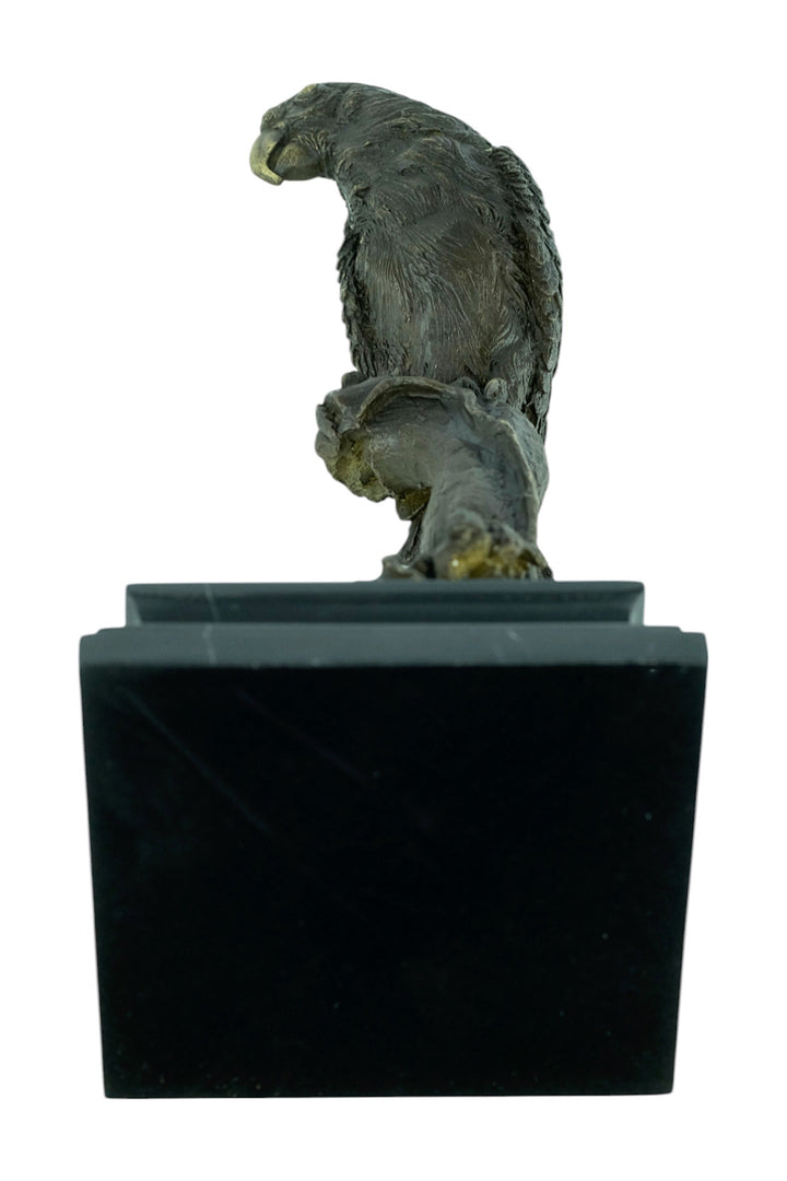 Bronze sculpture of a parrot sitting on a branch