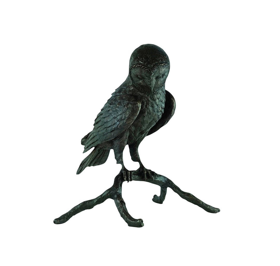 Large bronze sculpture of an owl sitting on a branch