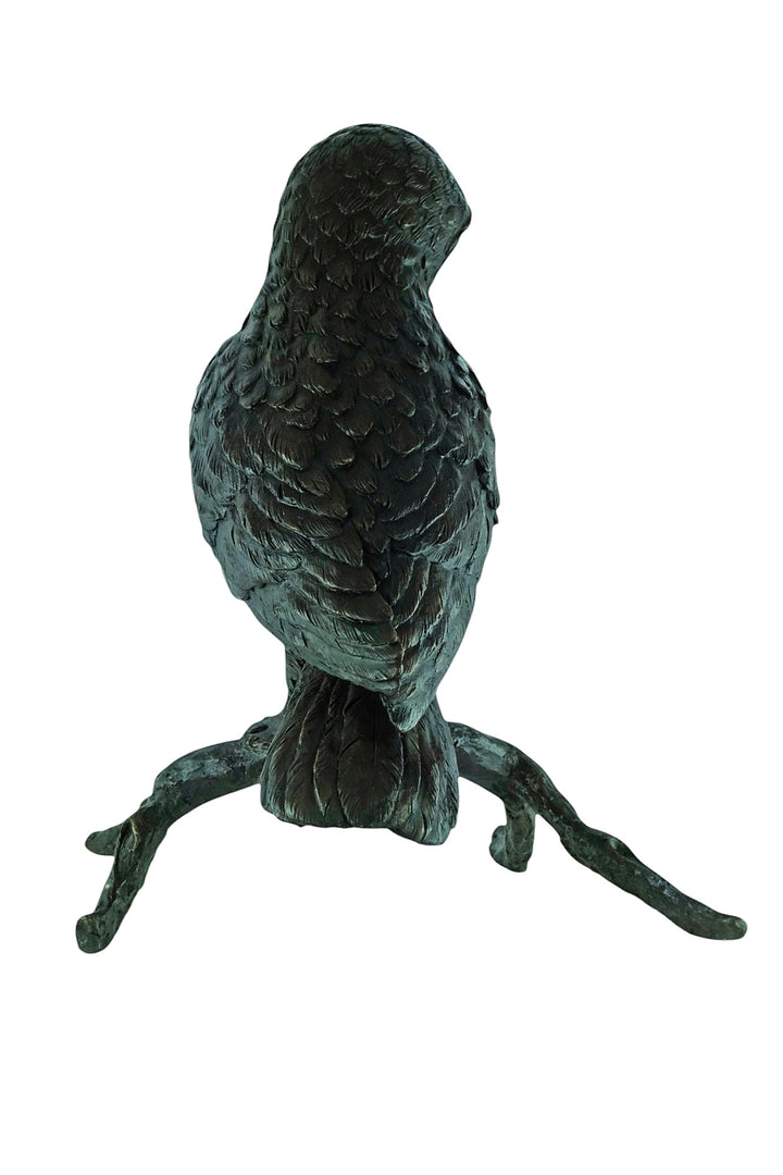 Large bronze sculpture of an owl sitting on a branch