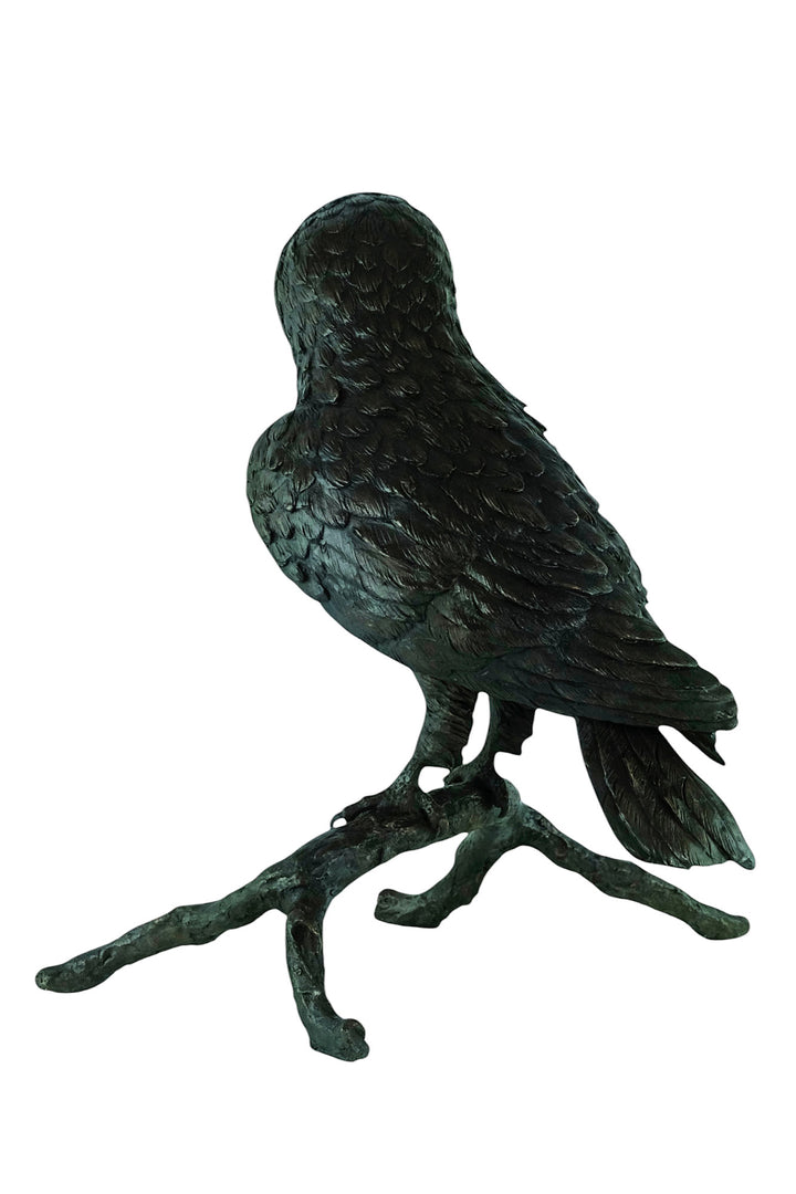 Large bronze sculpture of an owl sitting on a branch