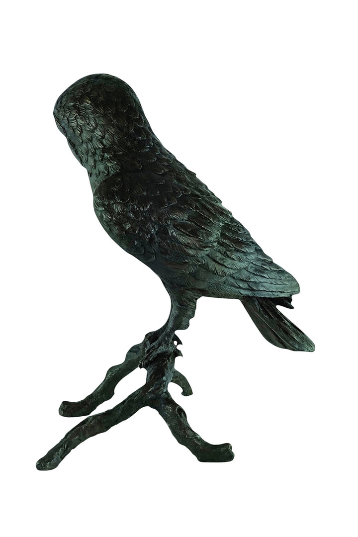 Large bronze sculpture of an owl sitting on a branch