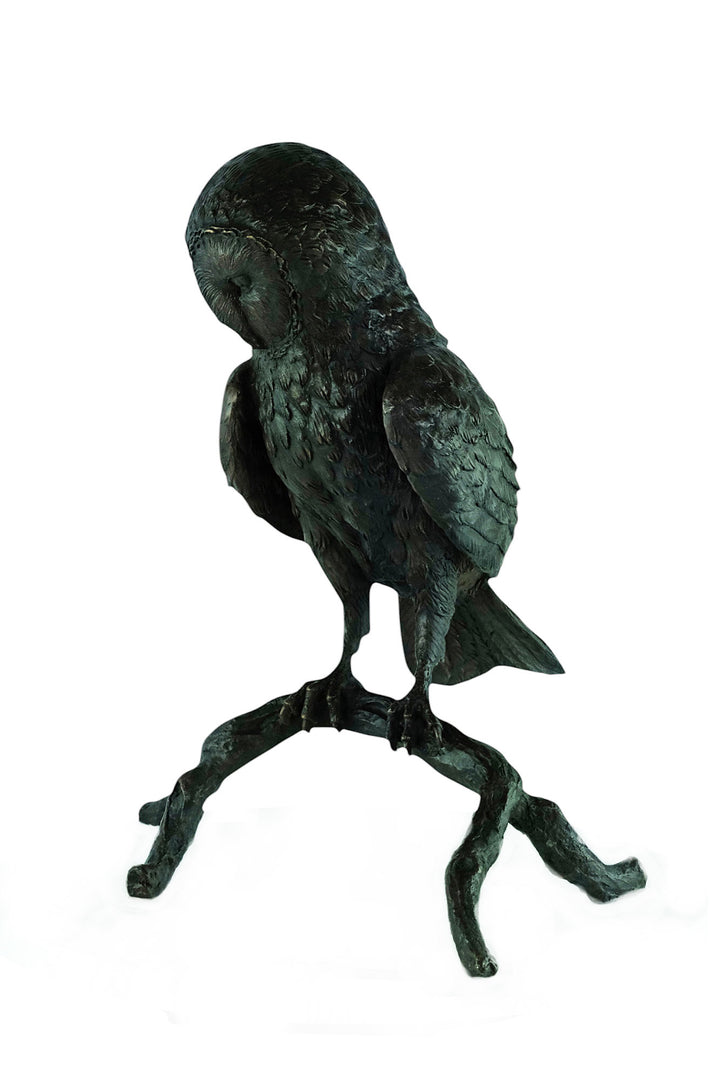 Large bronze sculpture of an owl sitting on a branch