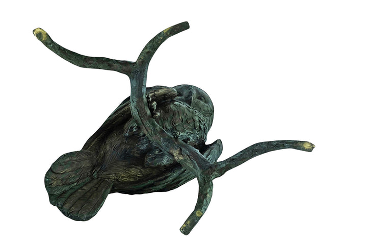 Large bronze sculpture of an owl sitting on a branch