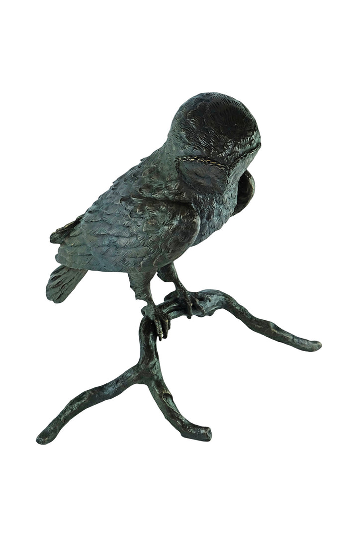 Large bronze sculpture of an owl sitting on a branch