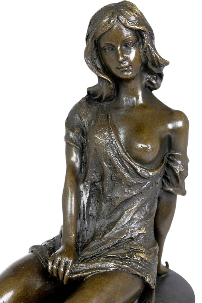 Bronze sculpture of a sitting female in flimsy dress