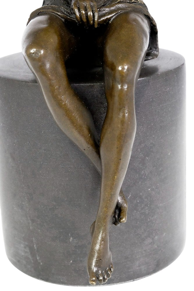 Bronze sculpture of a sitting female in flimsy dress