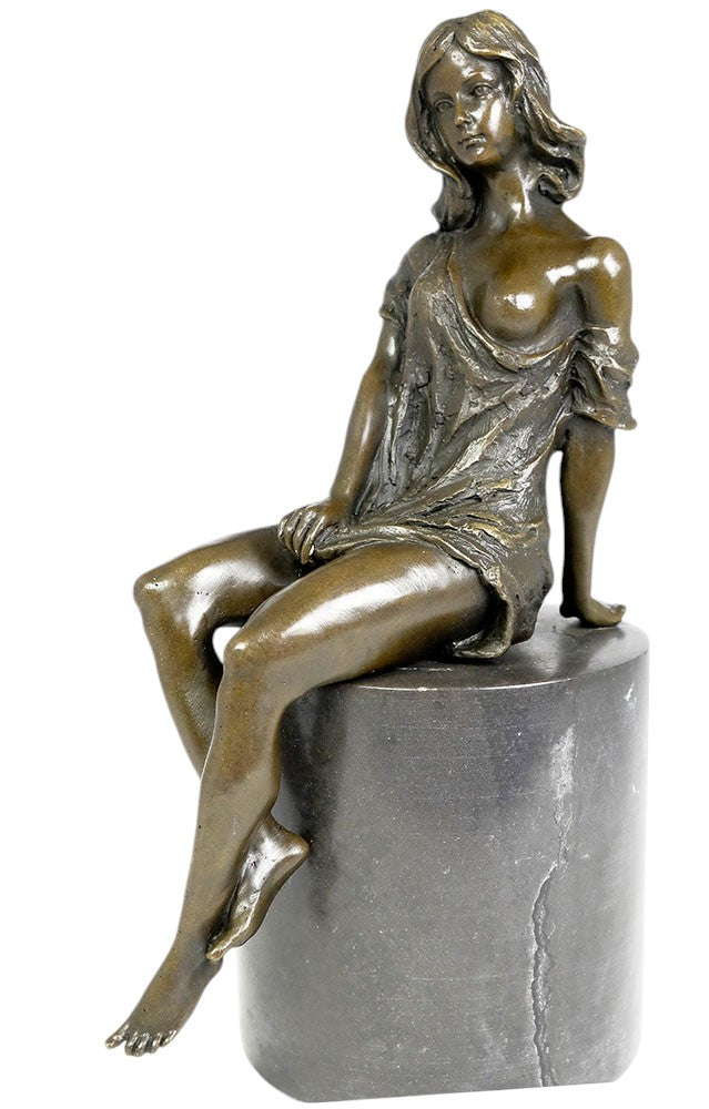 Bronze sculpture of a sitting female in flimsy dress