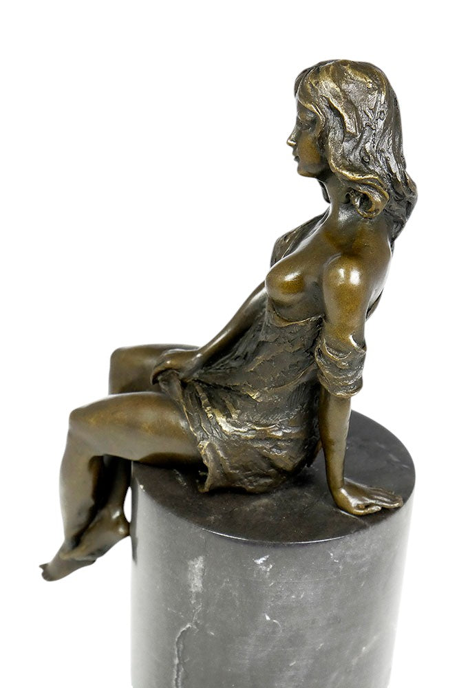 Bronze sculpture of a sitting female in flimsy dress