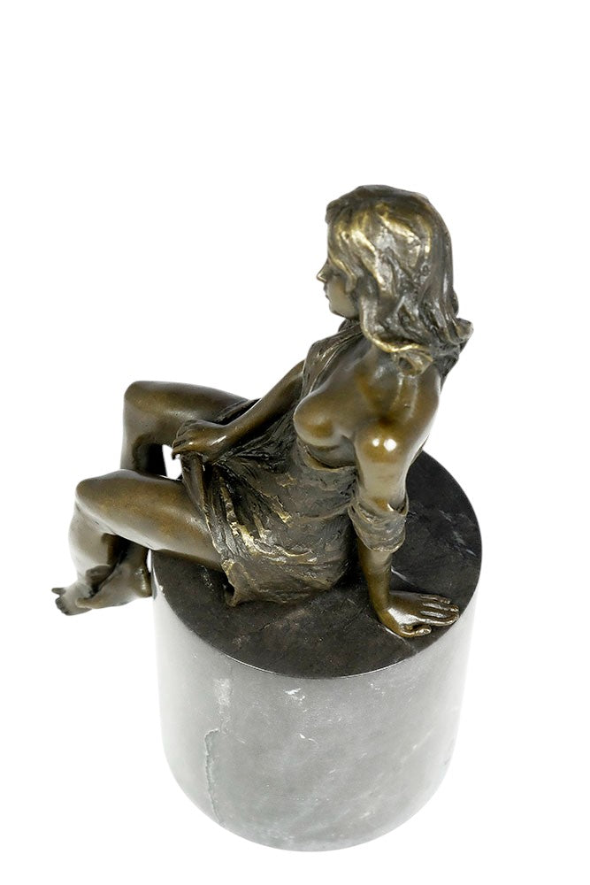 Bronze sculpture of a sitting female in flimsy dress