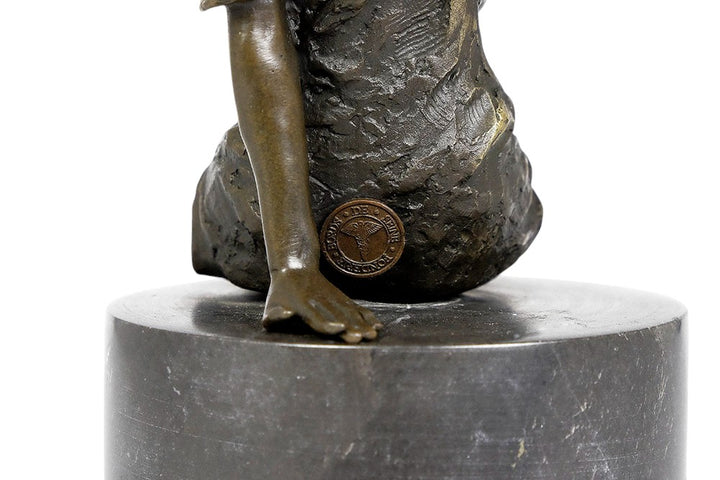 Bronze sculpture of a sitting female in flimsy dress