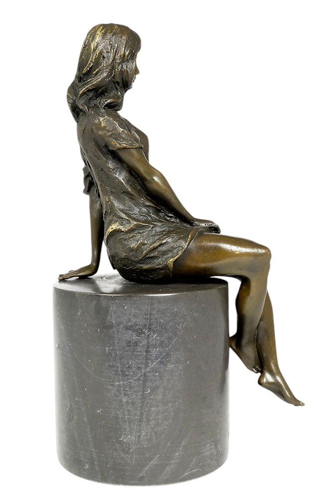 Bronze sculpture of a sitting female in flimsy dress