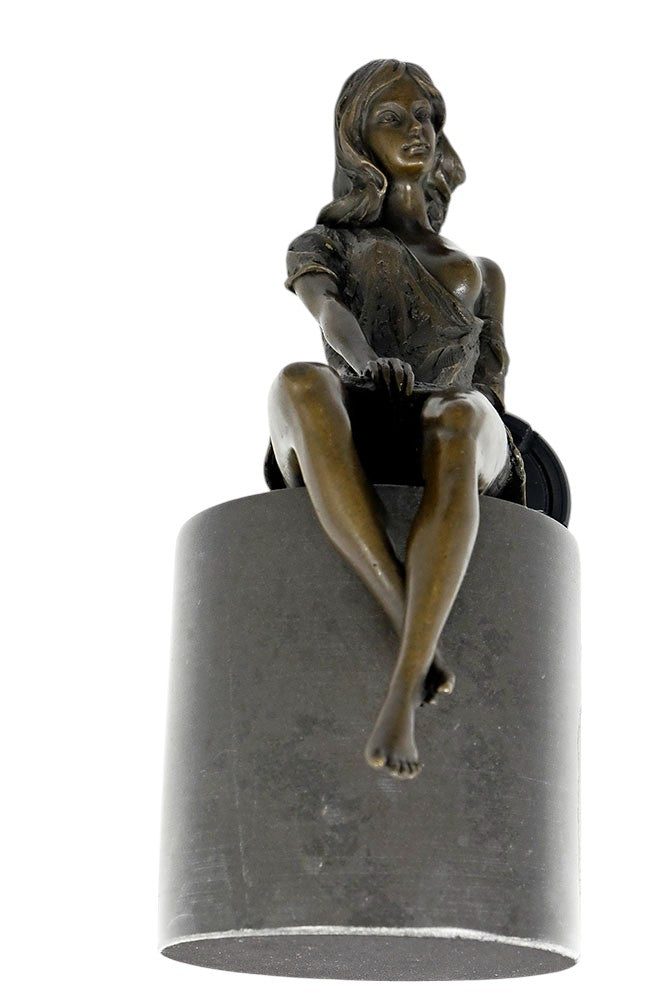 Bronze sculpture of a sitting female in flimsy dress