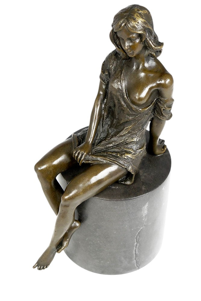 Bronze sculpture of a sitting female in flimsy dress