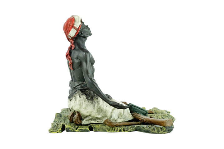 Bronze sculpture of an Arabian male on a rug selling weapons