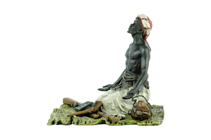 Bronze sculpture of an Arabian male on a rug selling weapons