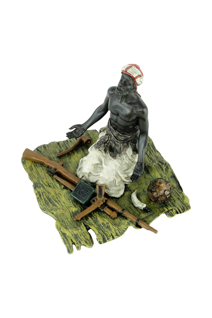 Bronze sculpture of an Arabian male on a rug selling weapons
