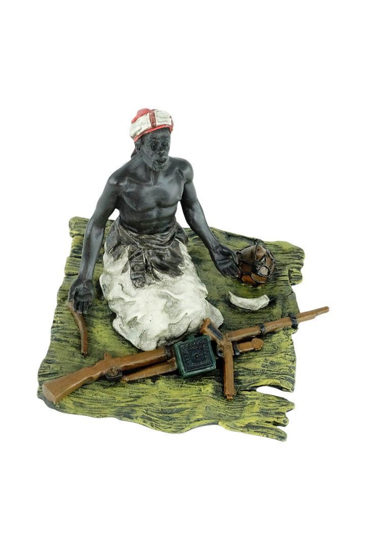 Bronze sculpture of an Arabian male on a rug selling weapons