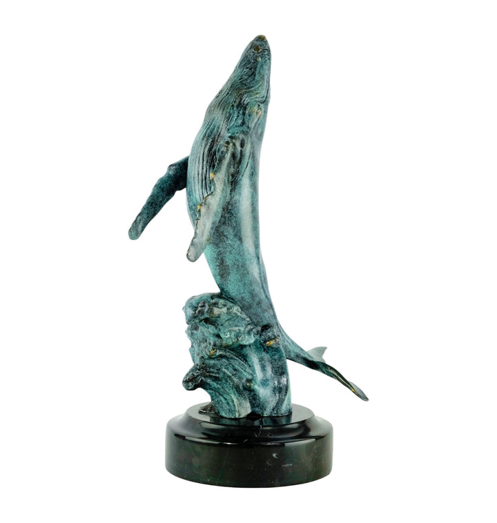 Bronze sculpture of a humpback whale breaching the surface