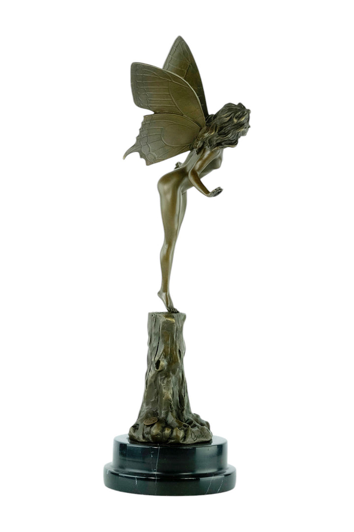 Bronze sculpture of a winged fairy standing on a tree trunk