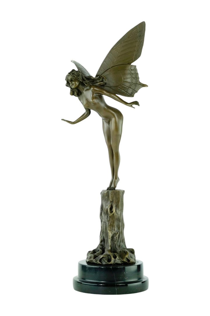 Bronze sculpture of a winged fairy standing on a tree trunk