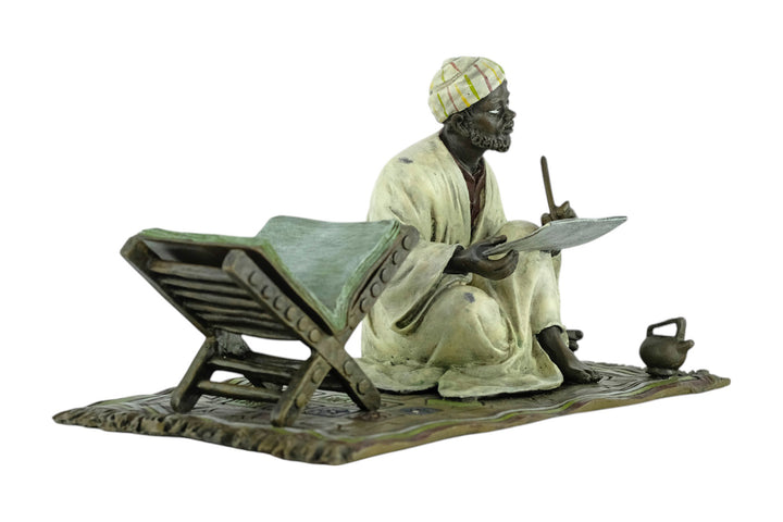 Bronze sculpture of a Quran scribe