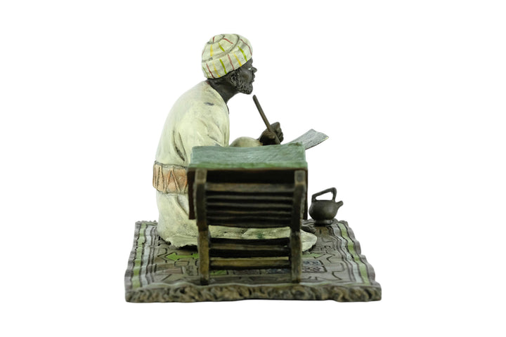 Bronze sculpture of a Quran scribe