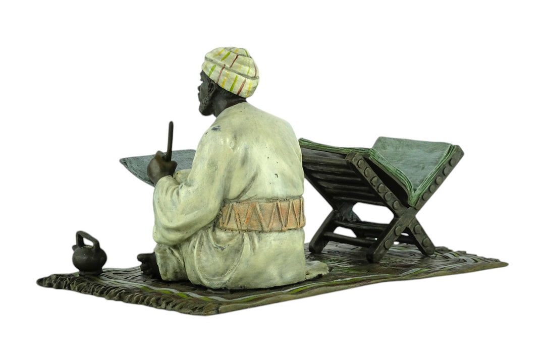 Bronze sculpture of a Quran scribe