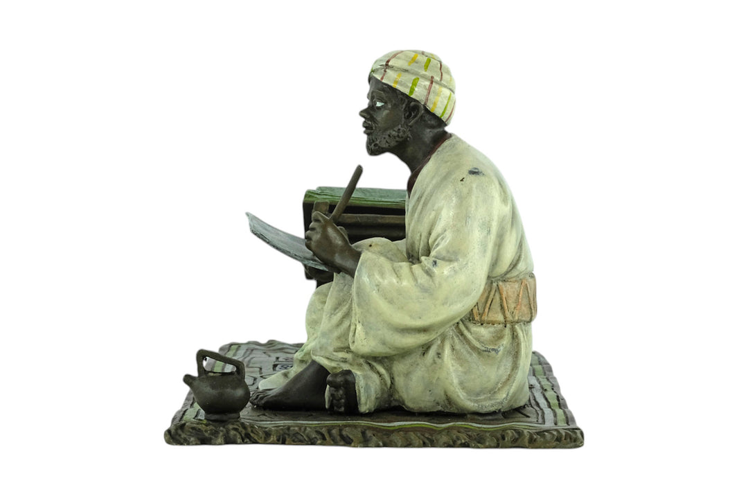 Bronze sculpture of a Quran scribe
