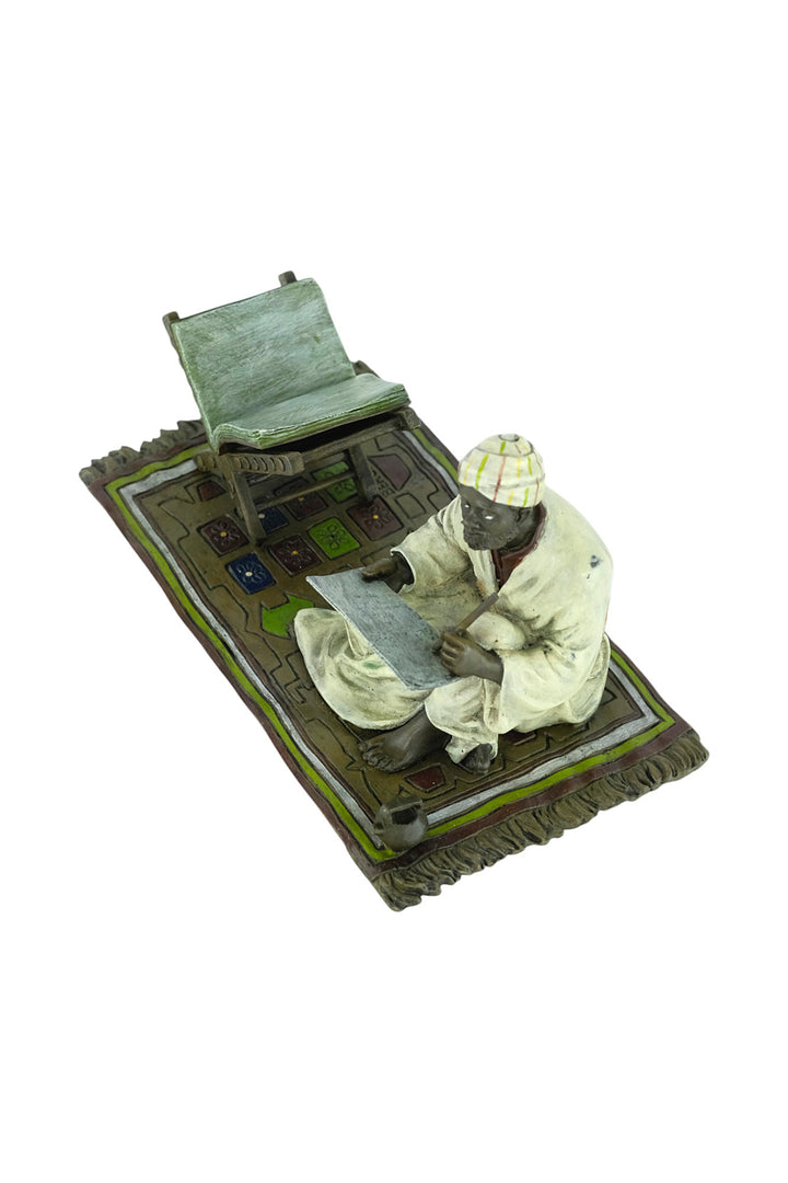 Bronze sculpture of a Quran scribe
