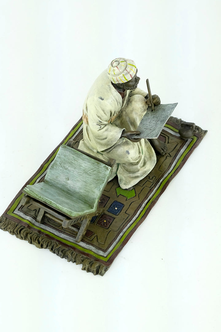 Bronze sculpture of a Quran scribe