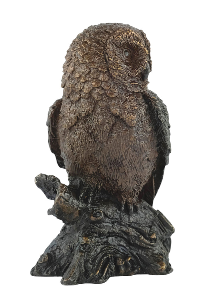 Bronze sculpture of a small own on a tree trunk