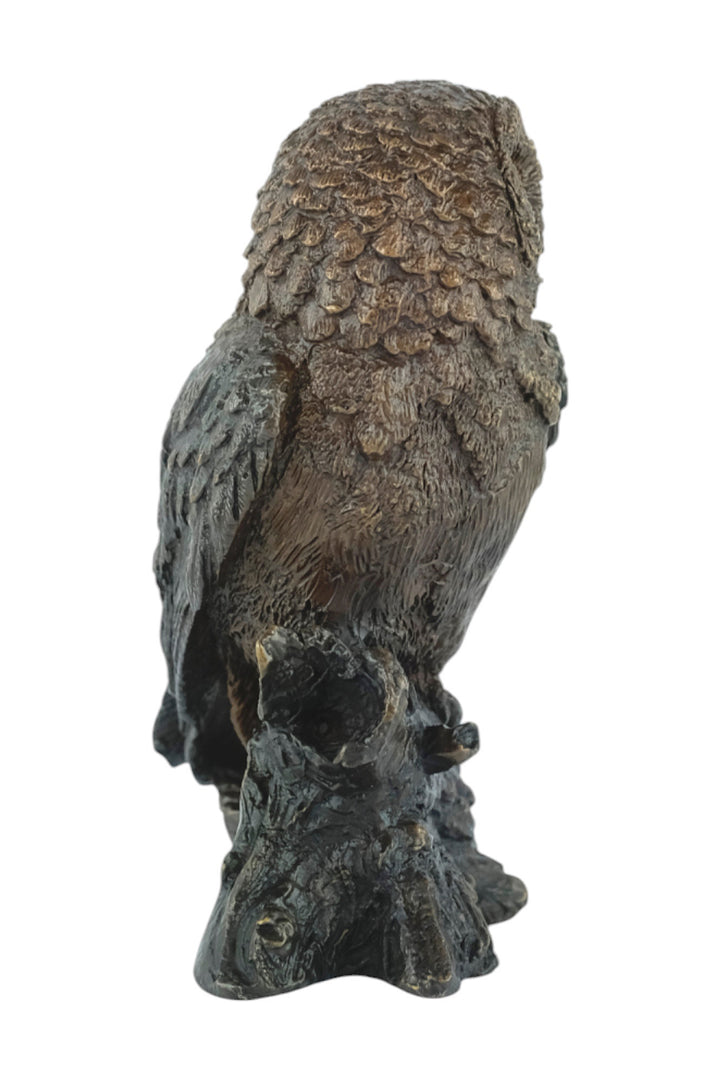 Bronze sculpture of a small own on a tree trunk