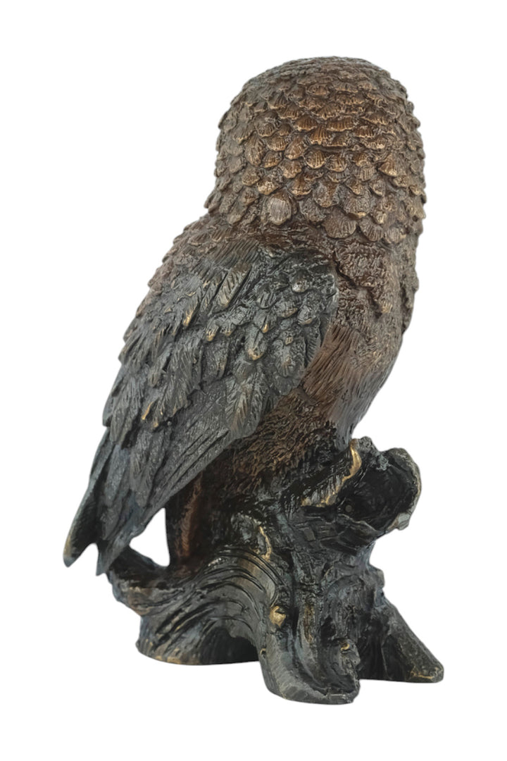 Bronze sculpture of a small own on a tree trunk