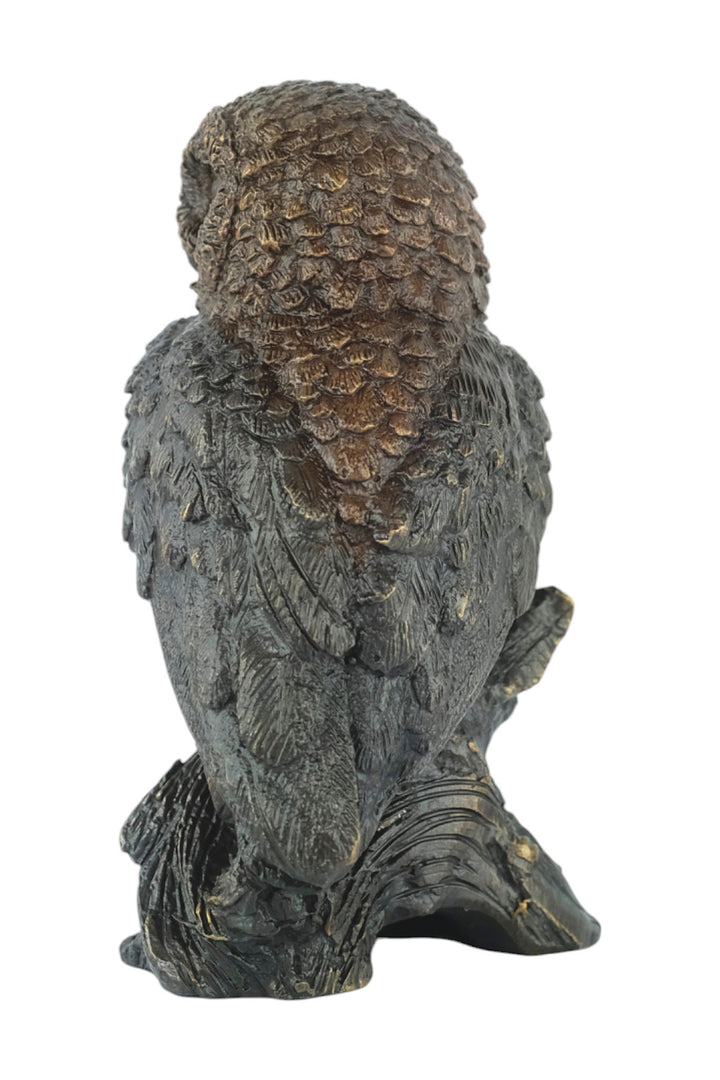 Bronze sculpture of a small own on a tree trunk