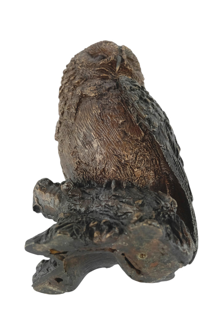 Bronze sculpture of a small own on a tree trunk