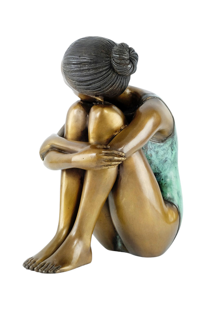 Bronze sculpture of a young girl in swimsuit resting her head