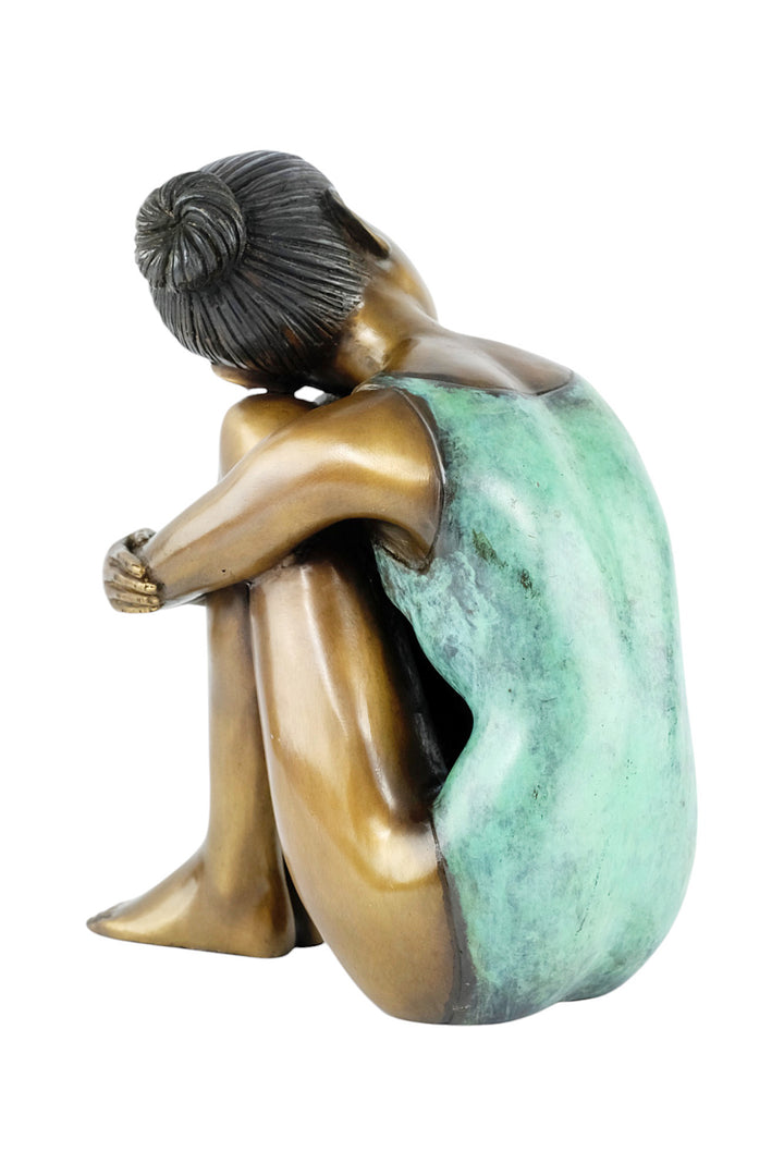 Bronze sculpture of a young girl in swimsuit resting her head