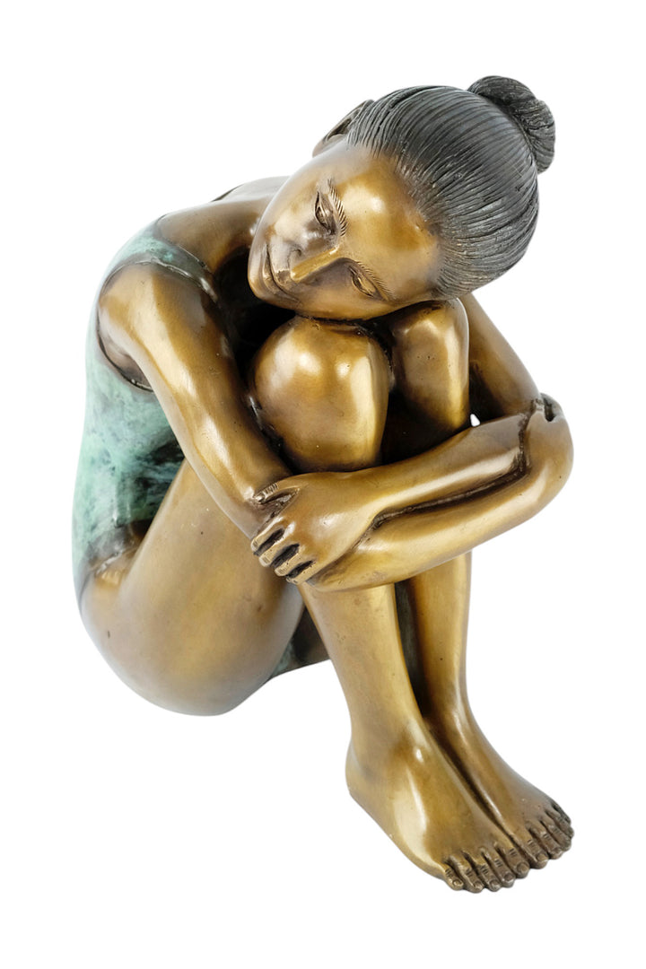 Bronze sculpture of a young girl in swimsuit resting her head