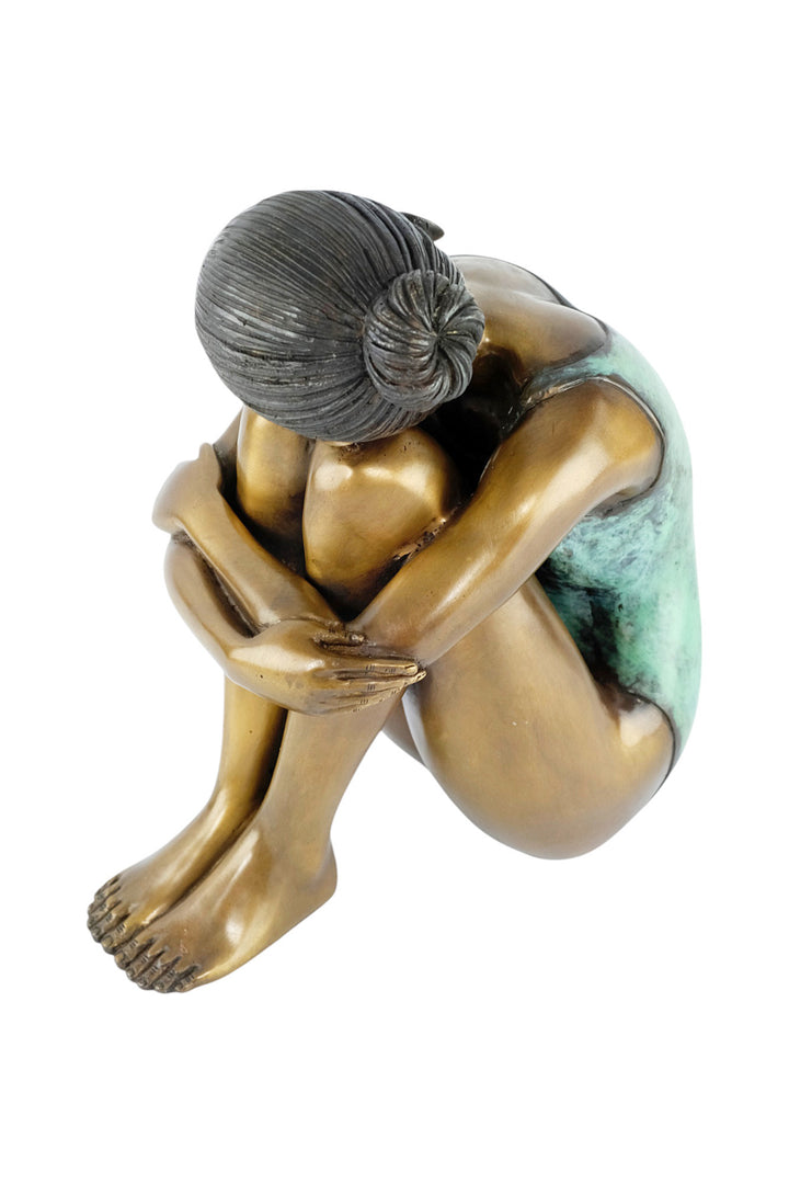 Bronze sculpture of a young girl in swimsuit resting her head