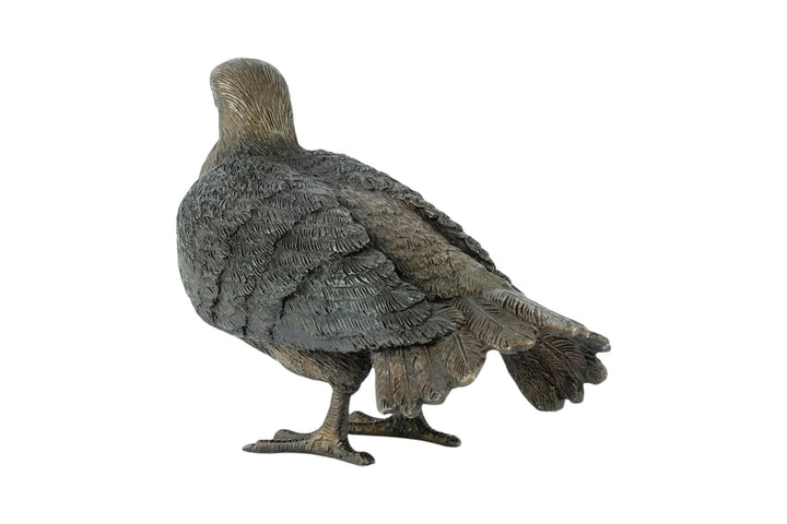 Bronze sculpture of a standing pigeon