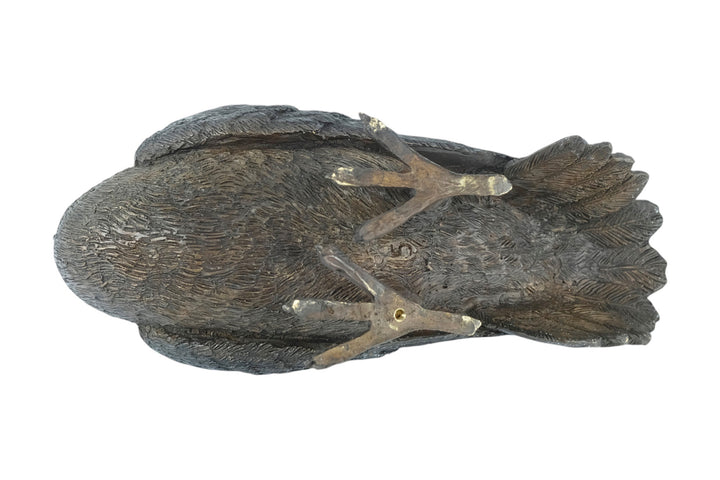 Bronze sculpture of a standing pigeon